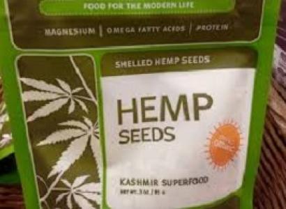 Green bag with white background and words Hemp Seeds and pictures of five leaf plants