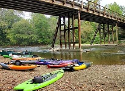 A river, a bridge and several kayaks