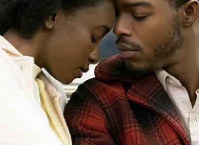 Black man and woman with eyes closed leaning their foreheads against each other
