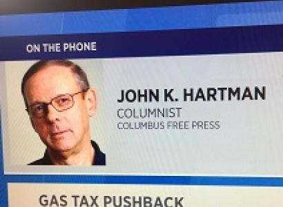 Screen shot of white man's head and the words John K. Hartman Columnist Columbus Free Press on the phone Gas Tax Pushback