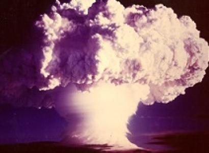 Big burst of a cloud in white all fluffy on top coming off of the ground