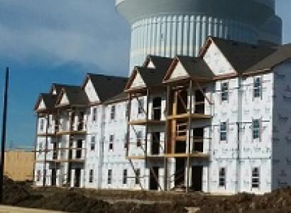 Big halfway built building with a huge water tower in the background