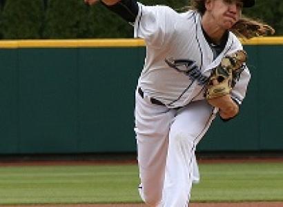 Pitcher throwing a pitch with long hair flying