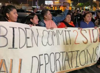 Immigrants holding a banner