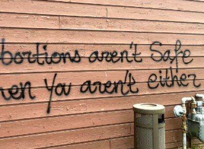Spray painting on wall saying If abortions aren't safe you aren't either