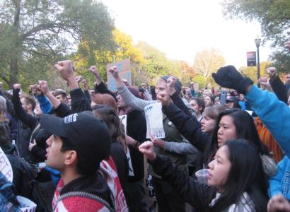 People with their fists in the air at an anti-Trump rally