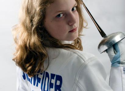 Very young blonde girl looking tough holding a sword