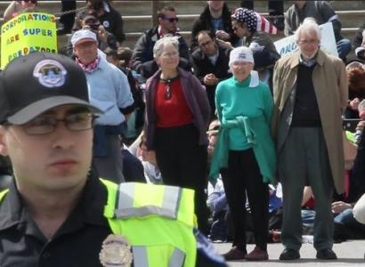 Demonstration with four people in handcuffs