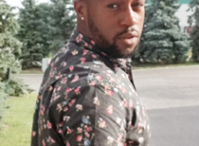 Black man turning to look behind him 