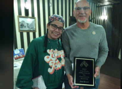 Woman and man with award