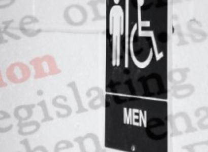 Men sign outside of bathroom