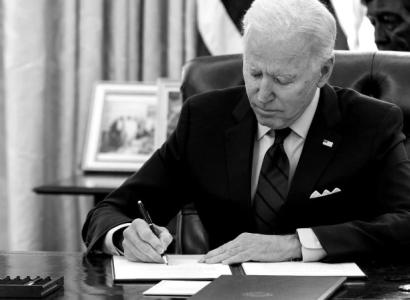 Biden at his desk signing something