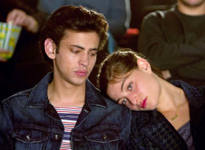 Girl with head on young man's shoulder