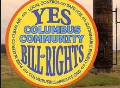 Columbus Community Bill of Rights in blue on yellow circle with YES at the top