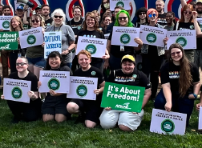 CMA workers with signs posing outside