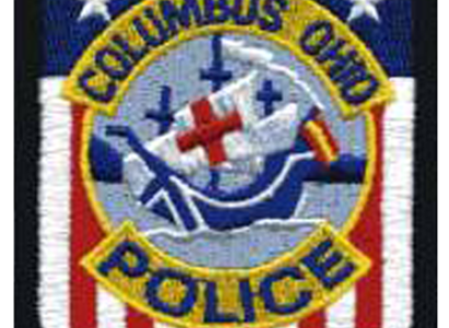 Badge with Santa Maria in center and red/white/blue background saying Columbus Ohio Police