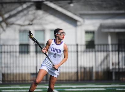 Kara Hines swinging a lacrosse stick