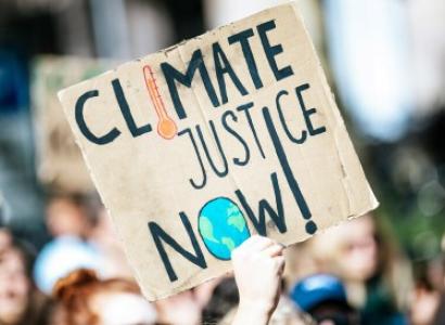 Sign saying climate justice now