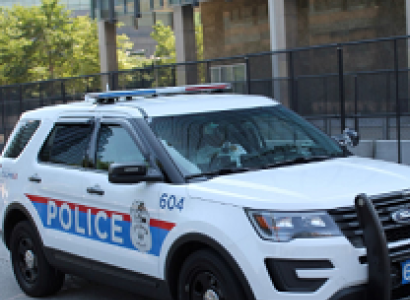 White SUV police vehicle with red and blue on the side saying POLICE