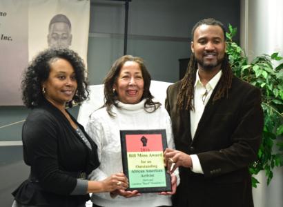 Sherri and Butch posing on each side of Ruth Moss holding award