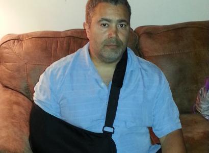 Dale Phillips with arm in sling from tendon injury