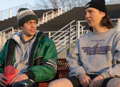 Two guys sitting outside 