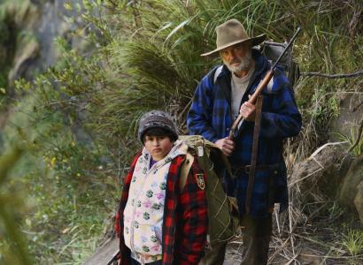 Man and young boy hiking on mountain