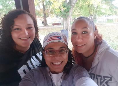 Three women including Esther in the middle