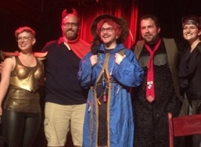 Four people dressed in geeky costumes