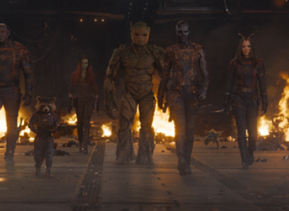 Characters walking in a line with fire in the background