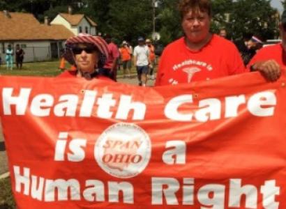 People marching holding sign