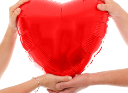 Two hands holding a big red heart