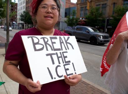 Woman with sign saying Break the ICE