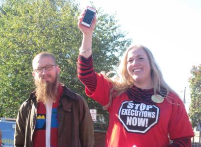 Death row inmate Keith LaMar speaks on the phone to participants in the Walk to Stop Executions as they prepare to walk the last two miles to the Ohio Statehouse on October 10.