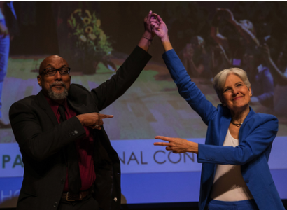 Ajamu and Jill holding up their hands in victory