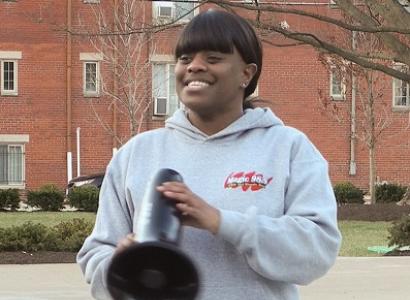 Young black woman with bullhorn outside at rally