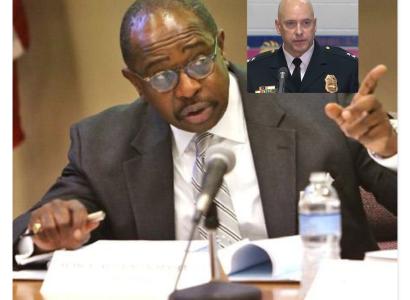 Black man pointing and talking into a mic