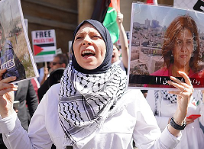 Woman protesting and holding photo of Shireen