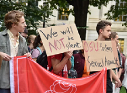 Young white people holding a big DSA sign marching