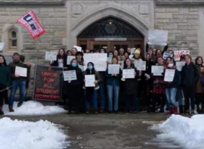 Students holding signs