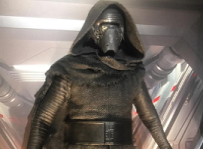 Guy in gold spacesuit looking outfit with helmet and facemask and hood from Star Wars