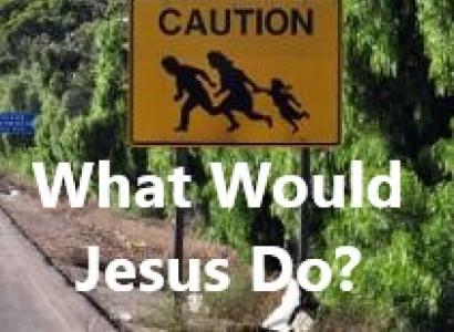 A yellow street sign that shows a family running across a street and the words CAUTION against trees and the words below What Would Jesus Do?