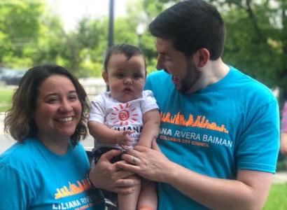 A young couple and the man holding a baby