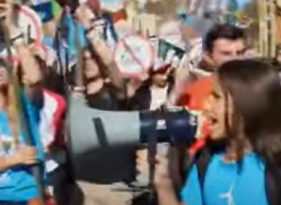 People marching, girl shouting into megaphone