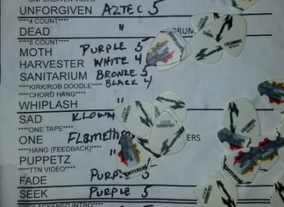 A list of bands with a lot of handwritten notes all over it