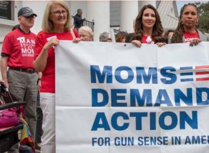 Women holding Moms Demand Action banner