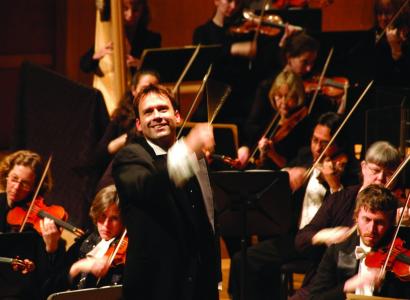 Man in front of orchestra conducting