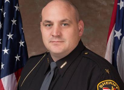 Bald white man in a sheriff uniform