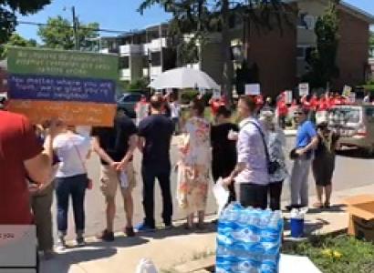 People on both sides of a street protesting each other