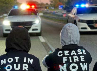People protesting blocking police cars